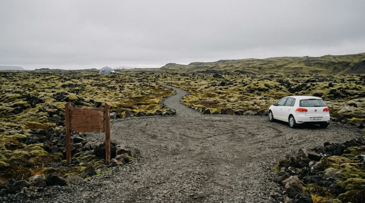 Gravel car park and small brown national park sign at the Vatnshellir cave entrance on Route 574 in Snæfellsjökull National Park