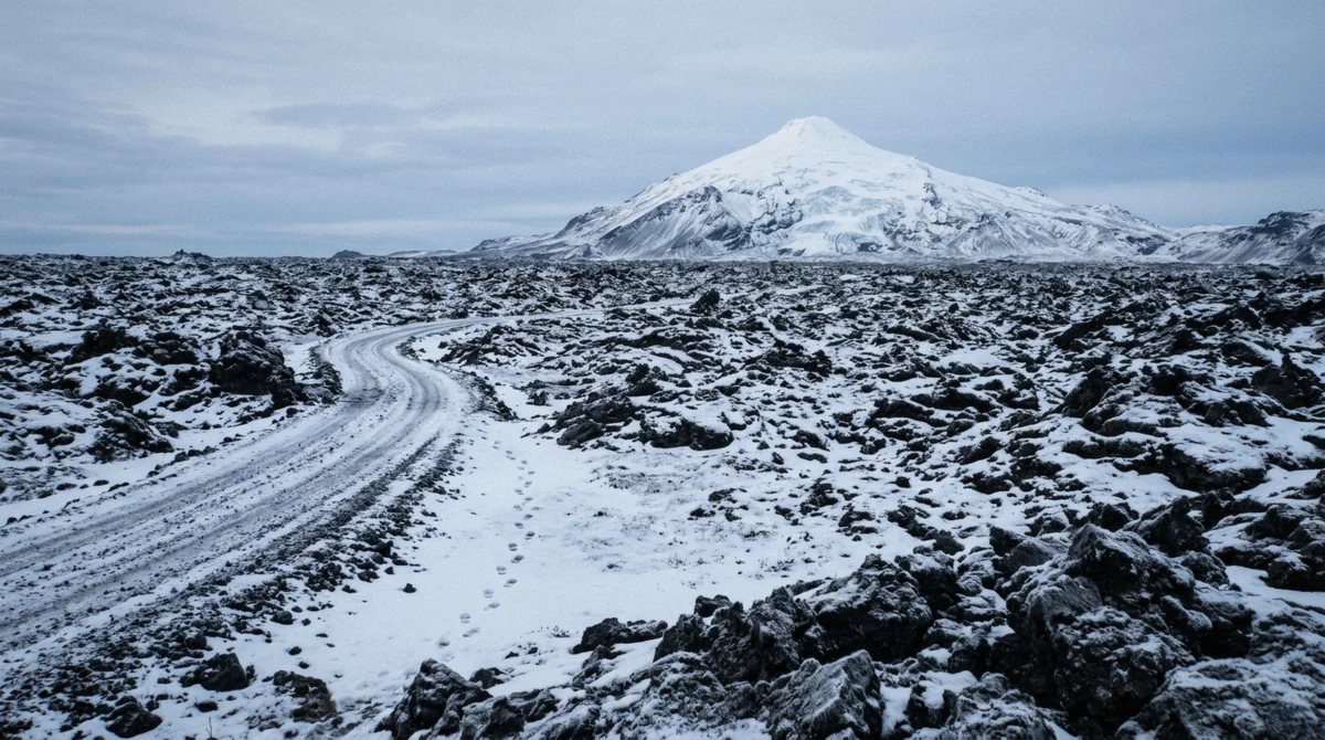 Snow-dusted lava field below Snæfellsjökull glacier above the Vatnshellir lava cave in winter in Iceland